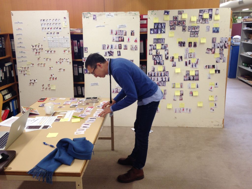 Senior Curator Roger Leong at work on a series of pin up boards
